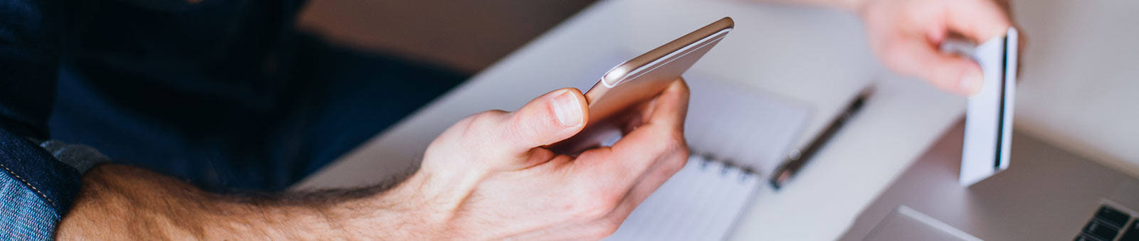 Man holding card and phone