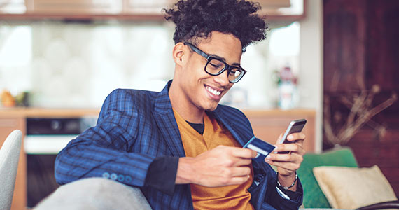 Man holding phone and card