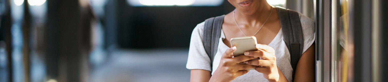 Woman holding phone in hallway